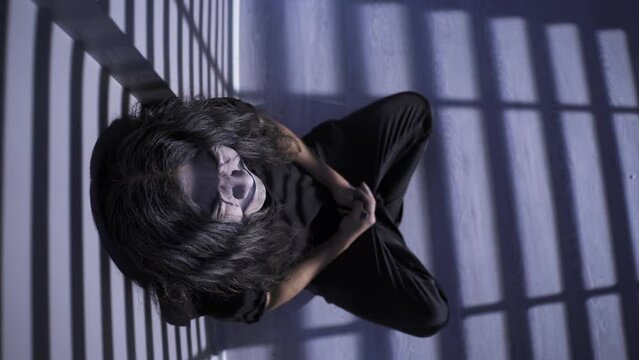 Crying emo teenager leaning against the wall.
The emo teenager who has lost his self-confidence is crying by the wall.
