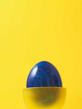 Blue Easter Egg In Yellow Eggcup