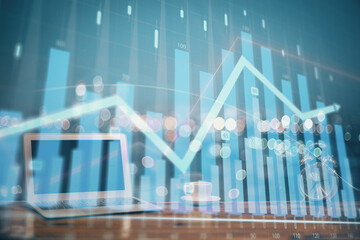 Stock market graph and table with computer background. Double exposure. Concept of financial analysis.