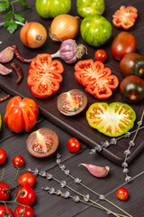 Fototapeta na wymiar Tomatoes of different varieties on cutting board.