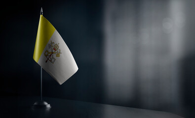 Small national flag of the Vatican on a black background
