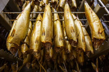 Closeup view of smoked mackerel in factory oven.