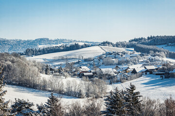 Daytime winter landscape: Beautiful view at hills and trees at bavarian forest, germany