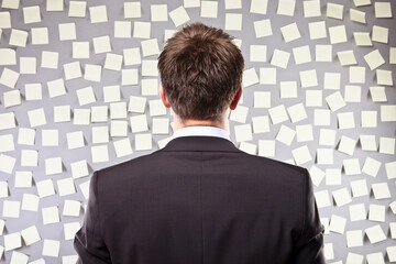 Businessman Looking at a Wall Full of Self Adhesive Notes