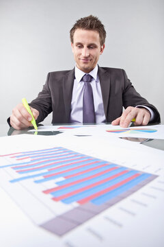 Businessman Looking at Graphs