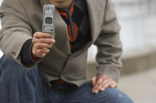 Man Taking Photo With Cell Phone