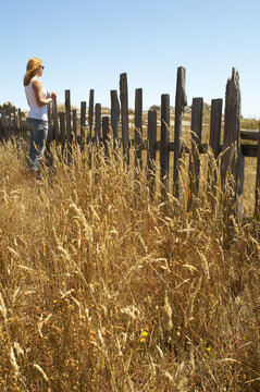 Woman Standing by Fence, Mendocino Coast, California, USA