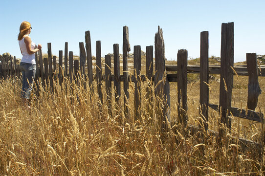 Woman Standing by Fence, Mendocino Coast, California, USA