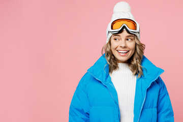 Snowboarder amazed fun woman wear blue suit goggles mask hat ski padded jacket spend extreme weekend look aside on area isolated on plain pastel pink background. Winter sport hobby trip relax concept.