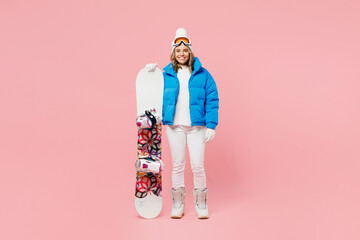 Full body snowboarder happy fun woman wear blue suit goggles mask hat ski padded jacket hold...