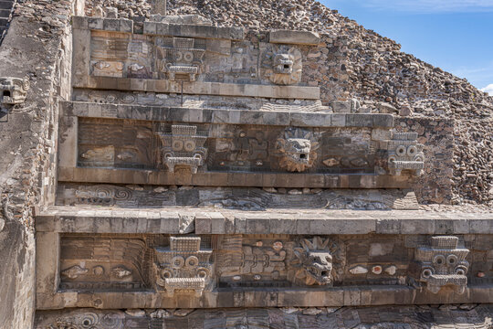 Carved heads depicting feathered snake heads in the Quetzalcoatl temple in Teotihuacan, Mexico.
Pyramid in honor of the God Quetzalcoatl represented by snake feathered serpent heads.