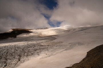 Magical view of glaciar Castaño Overo and Tronador hill summit covered by clouds.
