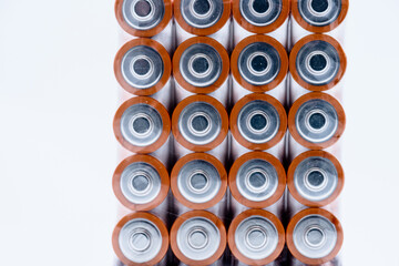 Four stacks of AA alkaline batteries.