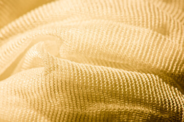 Macro photo of yellow mesh textile.