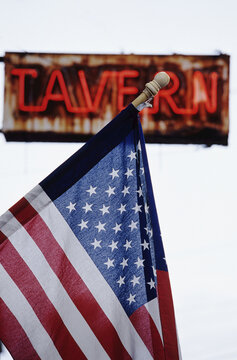 American Flag in Front of Tavern Sign