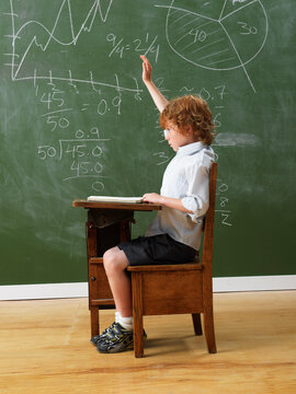 Boy Raising Hand at School