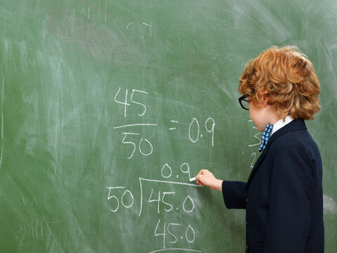 Boy Writing on Blackboard