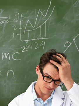Confused Scientist in Front of Blackboard