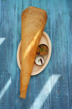 Dosa Filled With Curried Potato, Coconut Chutney, and Sambhar