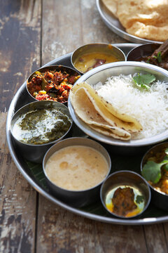 Thali, Kadai Bhindi, Mixed Vegetable Curry, Sambhar, Saag Paneer, Payasam, Mixed Pickle, and Chapati