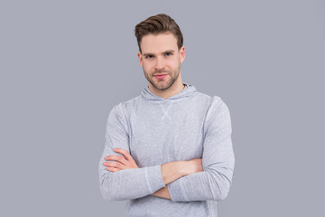Portrait of confident man. Handsome man keeping arms crossed. Young man with unshaven face