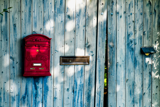 Wooden door and gate with red letterbox, Germany