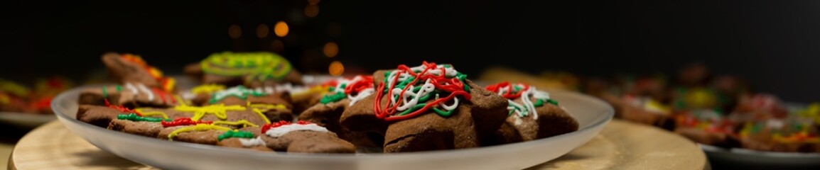 Making and decorating gingerbread cookies. Photo with colored ginger cakes.