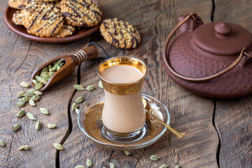 Chai Latte or Masala tea. Flavoured Cardamom Tea Latte made with milk, tea and mix of spices with...