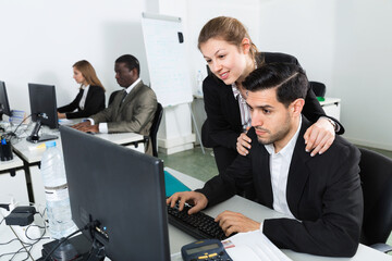 Sexual harassment between two satisfied smiling colleagues and flirting in office