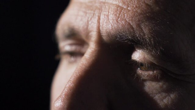 Close-up sad eyes of mature man.
Sad middle-aged man's eyes are full of tears, feeling unhappy and sad.
