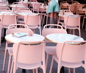 pink tables and chairs and a blue-dress waiter