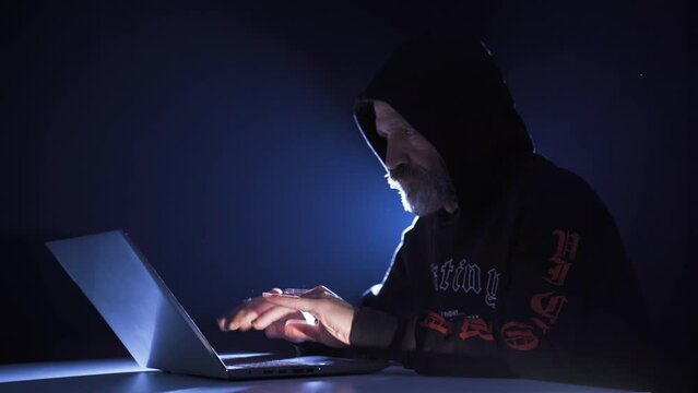 Hacker male commit crime from laptop by cracking password.
Hacker man starts typing on laptop keyboard and cracking password.
