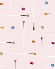 Pattern of vibrant christmas ornaments paintbrush on pastel pink background.  Flat lay design.