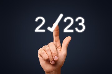 Businessman hand pointing on 2023 icon
