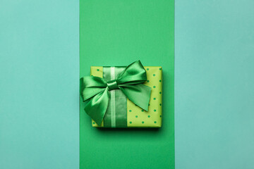 Gift box on blue and green background