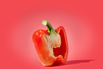 Half of red pepper on red background