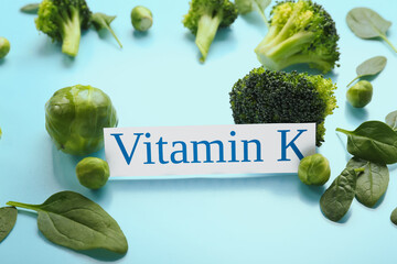Text VITAMIN K and healthy products on blue background