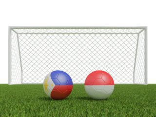 Footballs in flags colors on soccer field. Philippines with Indonesia. 3d rendering