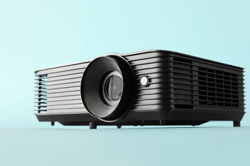 Black video projector on blue background