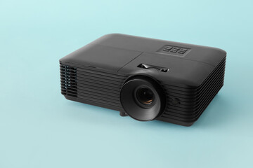 Black video projector on blue background