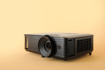 Black video projector on beige background
