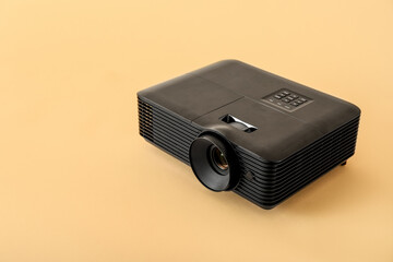 Black video projector on beige background