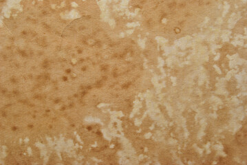 Grunge brown paper texture with stains as background
