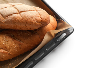 Baking sheet with loafs of fresh bread on white background, closeup