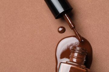 Spilled nail polish on brown background