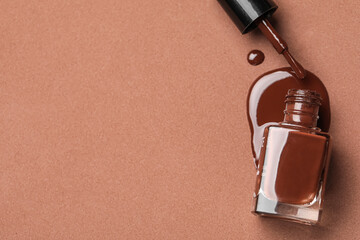 Spilled nail polish on brown background