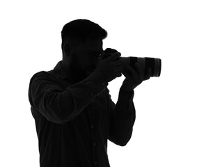 Fototapeta premium Silhouette of male photographer with camera on white background