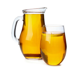 Glass and jug of fresh apple juice on white background