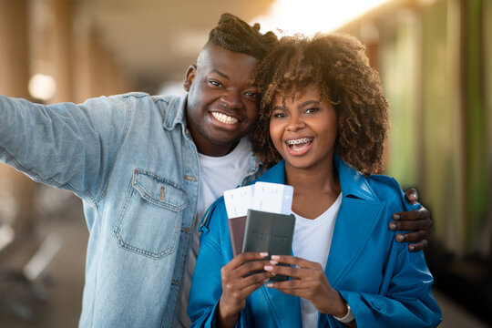 Happy Travellers. Smiling Young Black Couple Taking Selfie At Railway Station