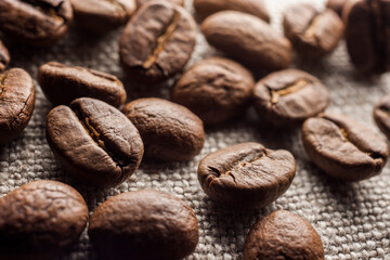 Arabica coffee beans on burlap texture